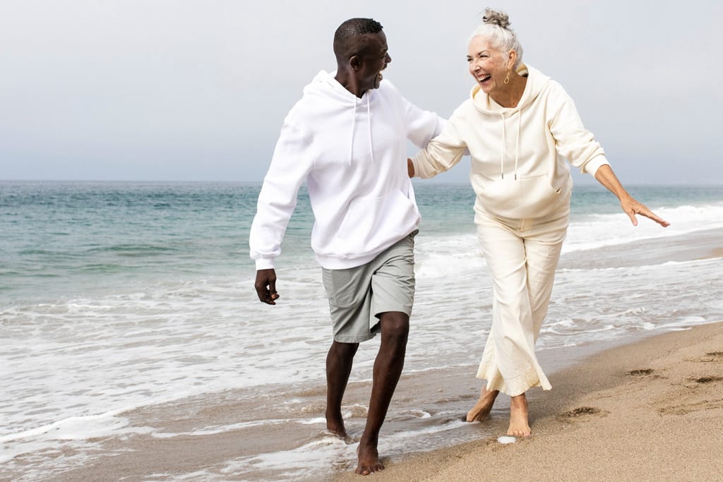 Happy senior couple at the beach during the winter