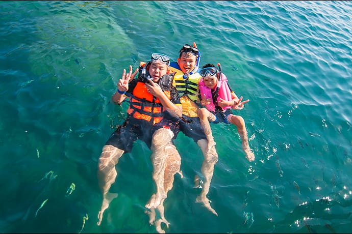 Three people snorkeling