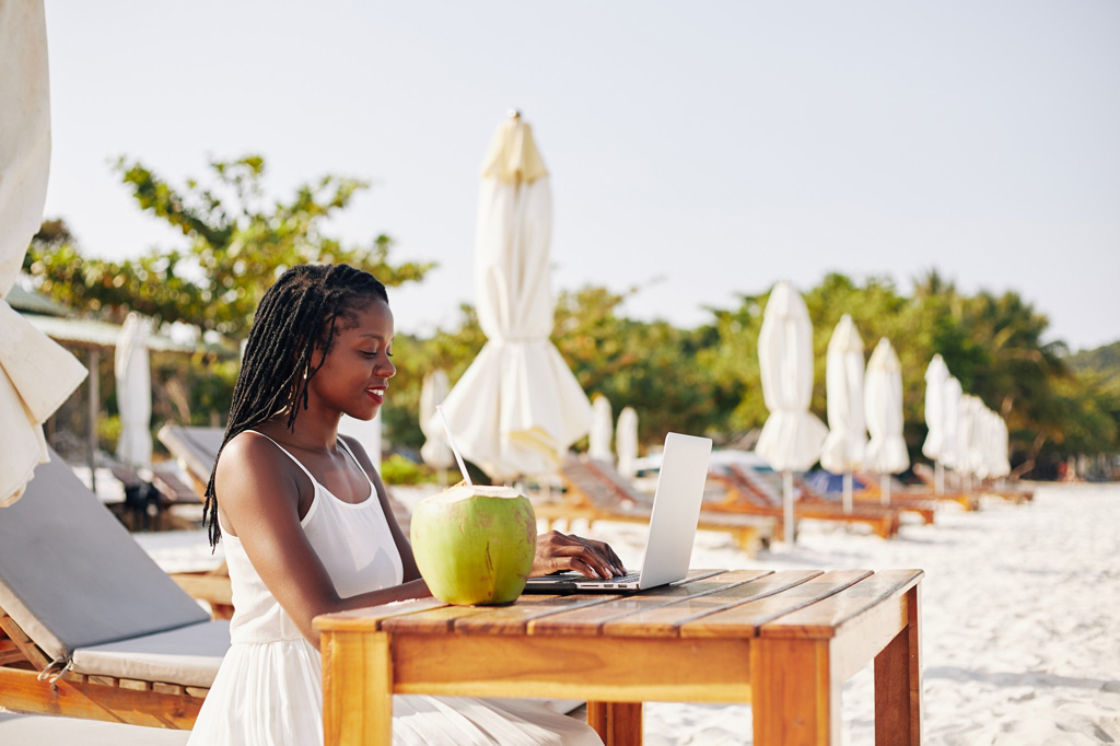 Woman looking at her laptop while at a resort