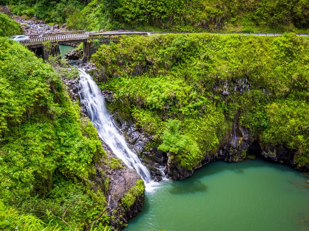 Waterfall and pool beneath a stone bridge on a Maui timeshare vacation