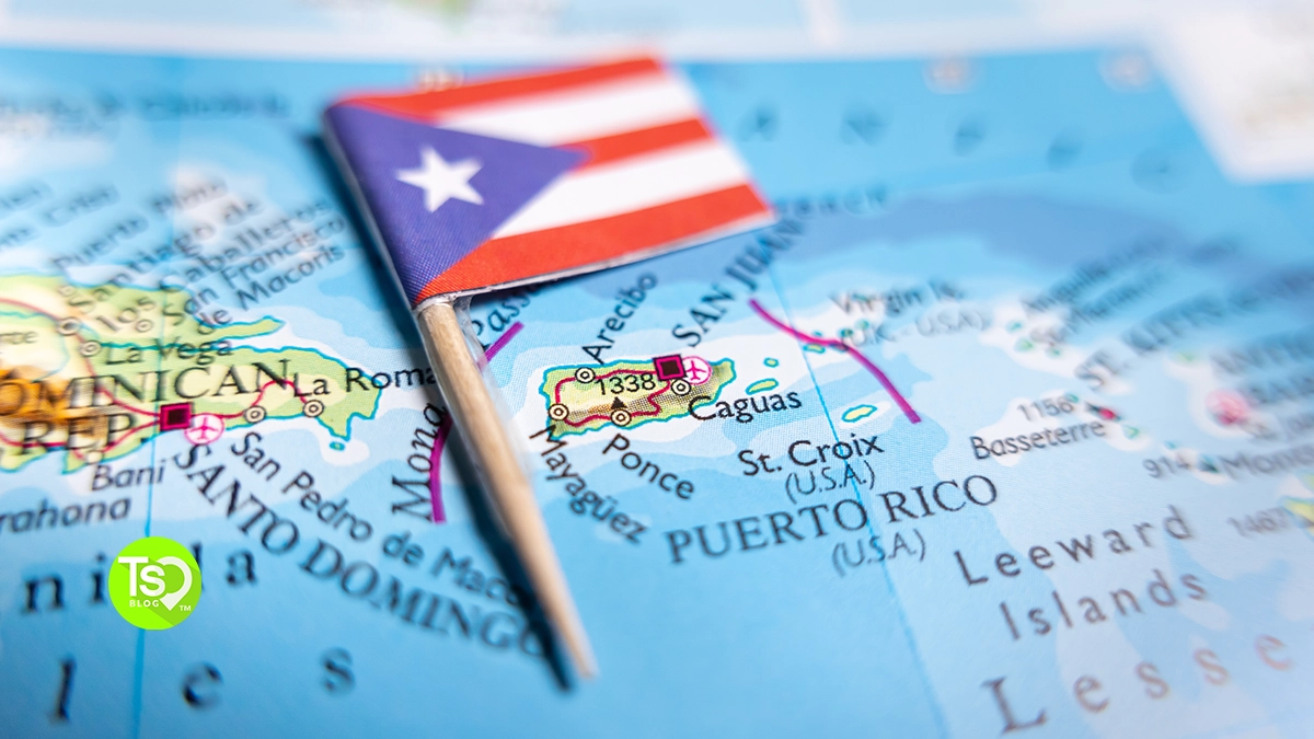 Puerto Rico flag pin marking the island on a map, with Santo Domingo and the Leeward Islands visible nearby.